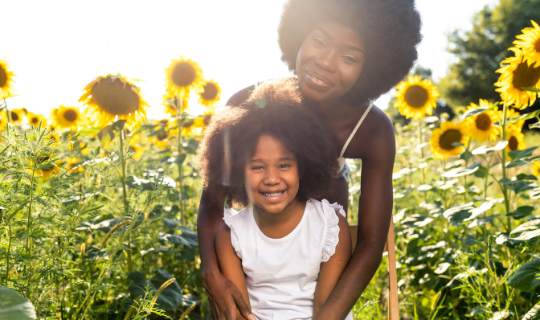 mama and daughter with sunflower